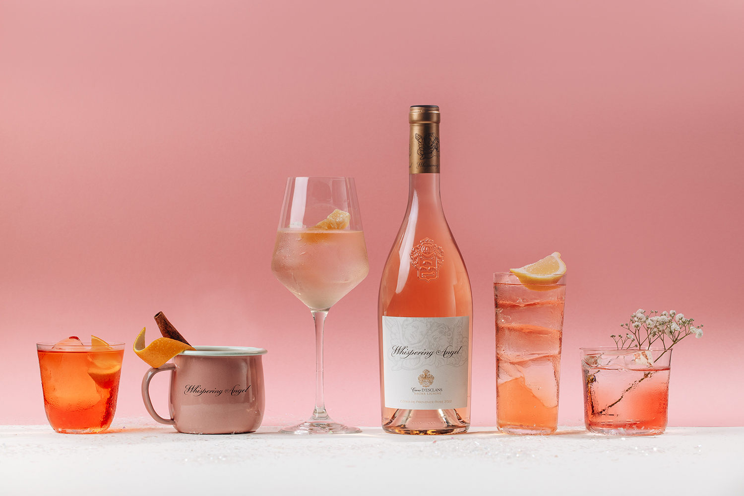 A selection of Whispering Angel drinks photgraphed on a pastel pink background. 